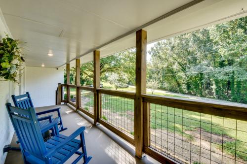 two blue chairs on a screened porch with windows at Quiet Countryside Getaway in Appalachian Foothills in Commerce