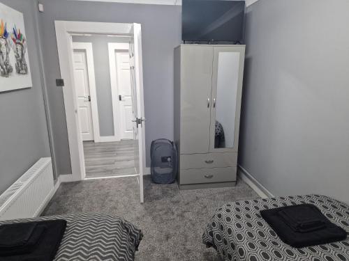 a bedroom with a bed and a dresser and a mirror at The Meadows in Market Drayton