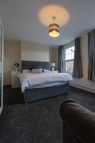 a bedroom with a large bed and a large window at Foresters arms in Warwick