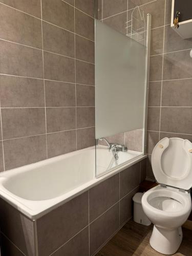 a bathroom with a white tub and a toilet at Studio La Plagne Villages in La Plagne Tarentaise