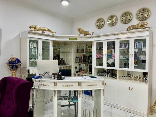 a white room with a desk and some plates at Campus Luxe Castle Hotel in Yerevan