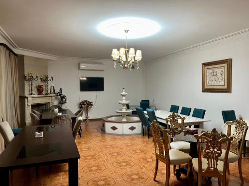 a living room with a table and a dining room at Campus Luxe Castle Hotel in Yerevan