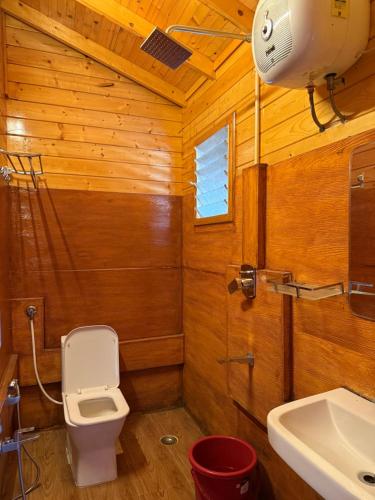 a bathroom with a toilet and a sink at The Pagodaa Resorts and Spa in Yercaud