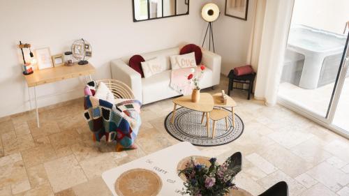 a living room with a couch and a table at Pâquerette in Arles
