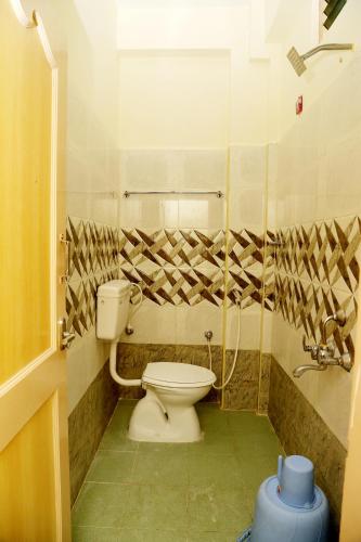 a bathroom with a toilet and a shower at Shubhanga Residency in Srikalahasti