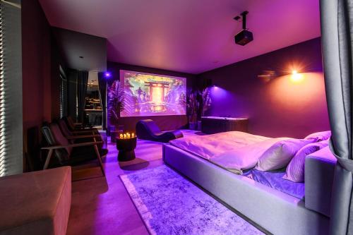 a purple bedroom with a large bed with a purple ceiling at Jacuzzi Cinema Japandi 2 in Kaunas