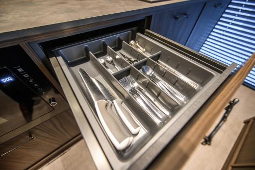 a drawer in a kitchen with utensils in it at Jacuzzi Cinema Japandi 2 in Kaunas