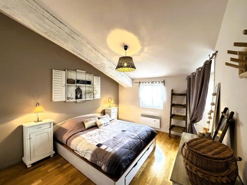 a bedroom with a large bed and a ceiling at Villa des Vignes et Spa in Quarante