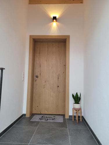 a wooden door in a room with a potted plant at Urlaub in Benediktbeuern in Benediktbeuern