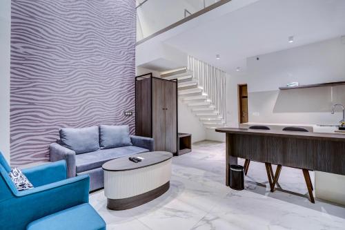 a living room with a couch and a table at Sunday Hotel & Residences Gurugram in Gurgaon