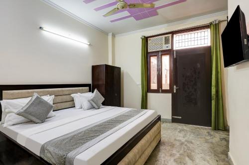 a bedroom with a bed and a ceiling fan at Hotel Sunshine By The Premium Villa in New Delhi