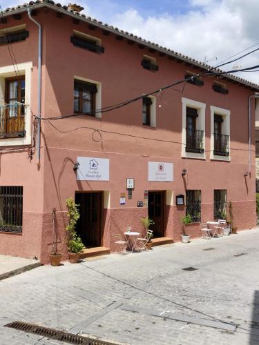 a red building with windows and a street at Casa Rural Parada Real CR-CC-00258 in Garganta la Olla