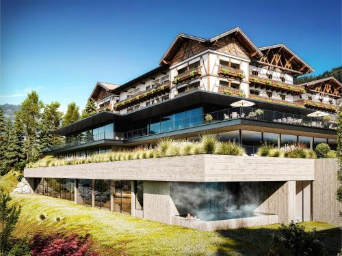 a large building on top of a hill at Hotel Oberforsthof in Sankt Johann im Pongau