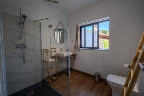 a bathroom with a shower and a toilet and a sink at Casa Camélia - The Valley Villas 