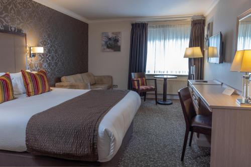 a hotel room with a bed and a desk at Ivy Hill Hotel, Sure Hotel Collection by Best Western in Chelmsford
