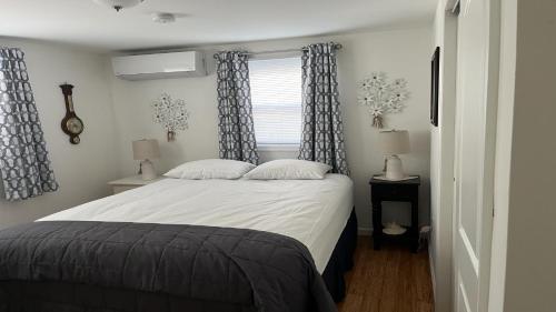 a bedroom with a bed and a window at Lbi Vacation Rental Property in Beach Haven