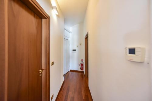 a hallway with a door and a television on a wall at Portico Juvarra in Turin
