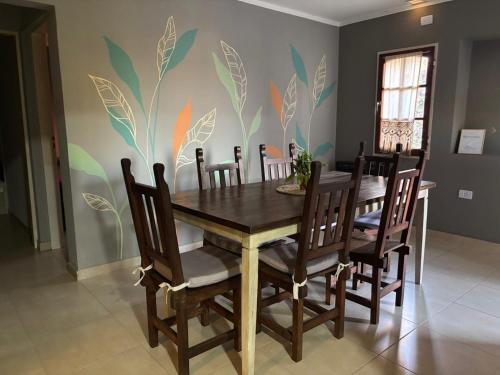 a dining room with a wooden table and chairs at Las Bahuinias in San Fernando del Valle de Catamarca