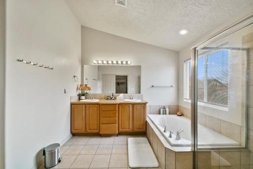 a bathroom with a tub and a sink and a shower at Boise Hills Luxurious Retreat in Boise