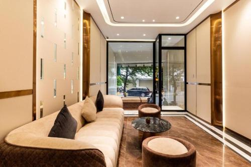 a living room with a couch and a table at Grand Mays Inn Hotel & Spa in Ho Chi Minh City