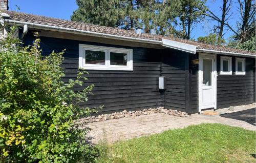 a small blue house with a white door at Stunning Home In Eskebjerg With Wifi in Eskebjerg