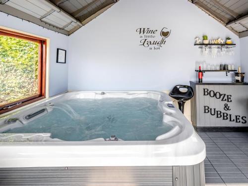 a large bath tub in a bathroom with a window at The Hawthorns in Ottringham