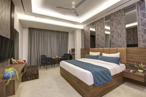 a hotel room with a bed and a television at Hotel Armani Free Airport Pickup Aur Drop in New Delhi