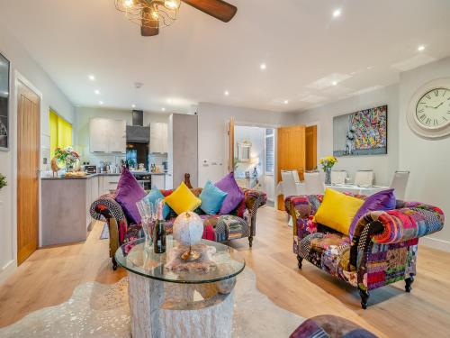 a living room with two couches and a table at Merriman Lodge in Glastonbury