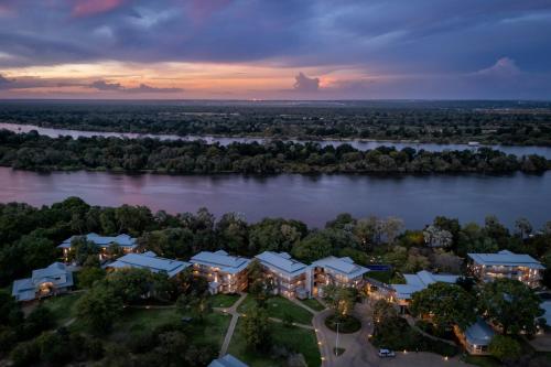 an aerial view of a house on the river at Palm River Hotel in Victoria Falls