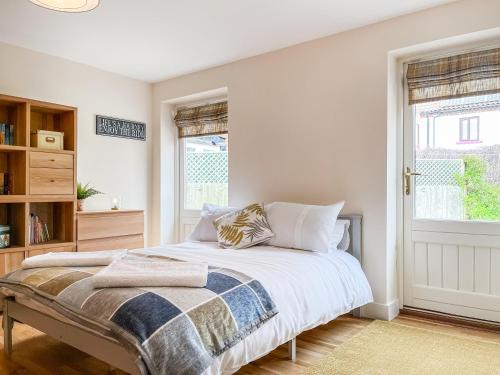 a bedroom with a bed and a window at The Willows in Teversal