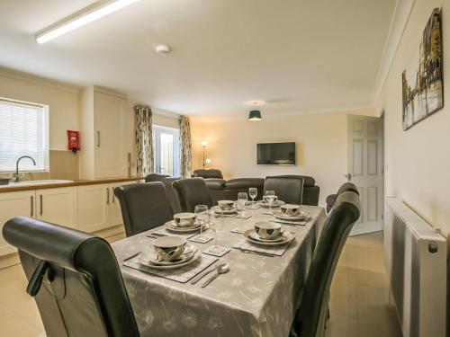 a dining room with a long table and chairs at 2 Dawson Court - Uk33411 in Mablethorpe