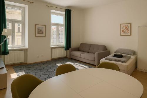 a living room with a table and a couch at Central Apartment in Vienna
