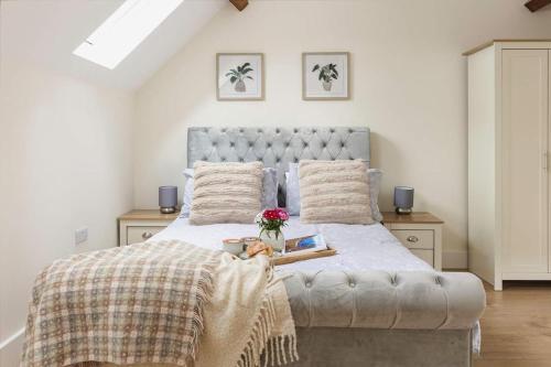 a bedroom with a large bed with a blanket and flowers at Home Farm Retreat in Cotesbach