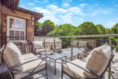a patio with two chairs and a table on a balcony at Bronte House in Kirkby Lonsdale