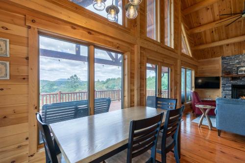 a dining room with a large wooden table and chairs at Chasing Clouds Cabin in Todd