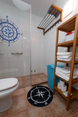 a bathroom with a toilet and a glass shower at apartamento anzuelo in Famara