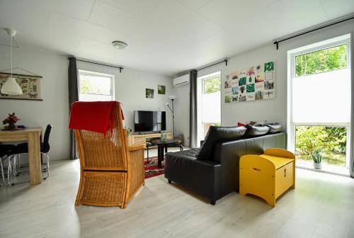 a living room with a couch and a table at Bungalow De Babbel | 4 persons in Gasselte