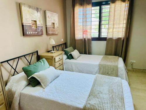 a bedroom with two beds and a window at Lux Villa with Year-Round Heated Pool & Game Room in Montequinto