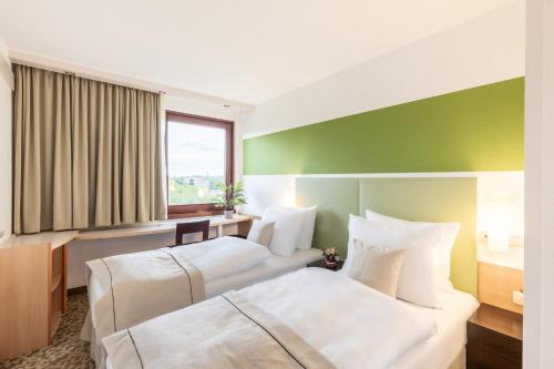 Postel nebo postele na pokoji v ubytování Garner Hotel Osnabrück by IHG