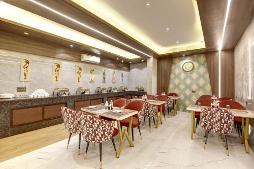 a restaurant with tables and chairs and a counter at Hotel Armani Free Airport Pickup Aur Drop in New Delhi