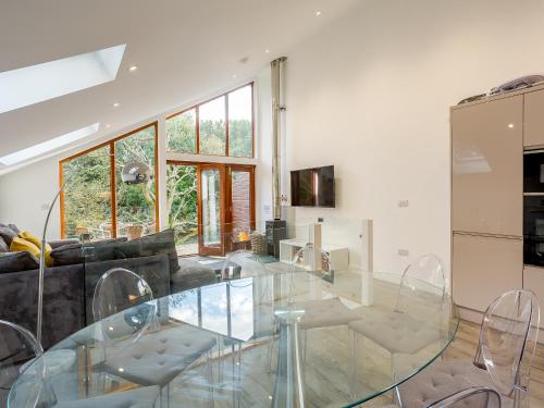 a living room with a glass table and chairs at Waterside Lodge One - Uk33351 in Southowram