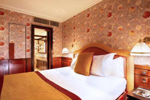 a bedroom with a bed and a wall with flowers at Grand Hotel de l'Opera - BW Premier Collection in Toulouse