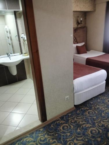 a hotel room with two beds and a sink at TAC MAHAL HOTEL in Ankara