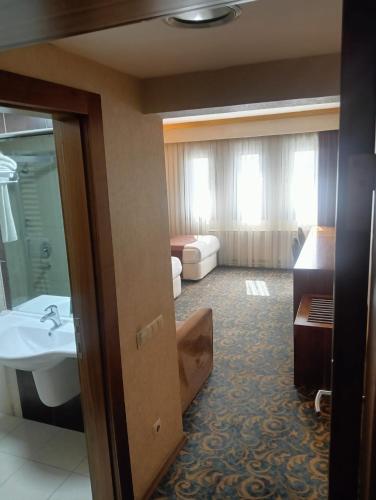 a hotel room with a sink and a bathroom at TAC MAHAL HOTEL in Ankara