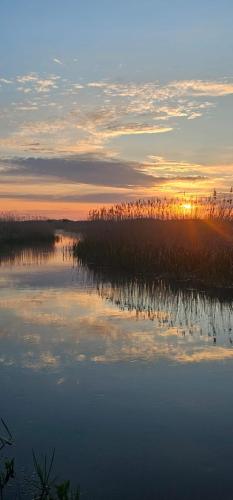 a reflection of the sunset in the water at Okoń in Sztabin