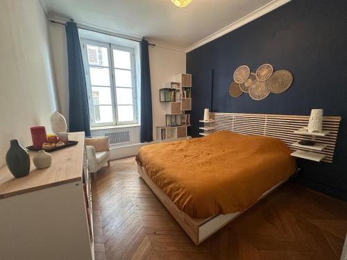 a bedroom with a large bed and a window at Herem Charme de l ancien en centre ville in Clermont-Ferrand