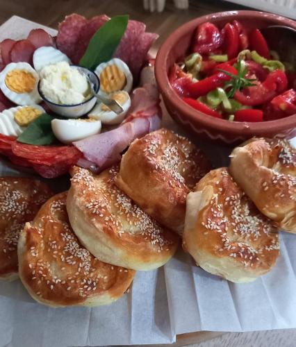 a plate of food with pastries and a bowl of vegetables at B&B Baš Baštica in Kladovo