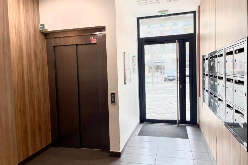 a hallway with a door to a building at Le Métropolitain - Grand studio coeur Tassin et gare in Tassin-la-Demi-Lune