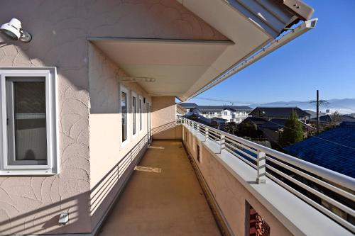an empty balcony of a building with a window at Maccha House Near Zenkoji Nagano in Nagano