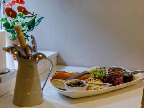 a plate of breakfast food on a table with a vase at The Grousemoor in Llandegla